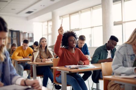 Classroom with one student raising her hand